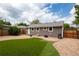 Spacious backyard featuring a manicured lawn, privacy fence, and cozy patio perfect for outdoor entertaining at 8240 Grandview Ave, Arvada, CO 80002