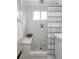 Bathroom featuring tiled shower with bench and striped curtain at 8240 Grandview Ave, Arvada, CO 80002