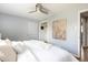 Bedroom with white comforter, ceiling fan and walk in closet at 8240 Grandview Ave, Arvada, CO 80002