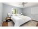 Bright bedroom with neutral decor, ceiling fan, and two windows at 8240 Grandview Ave, Arvada, CO 80002