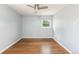 Bright bedroom with hardwood floors, a ceiling fan, and natural light from a window at 8240 Grandview Ave, Arvada, CO 80002