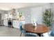 Bright dining area open to the kitchen with stainless steel appliances at 8240 Grandview Ave, Arvada, CO 80002
