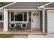Close-up of a welcoming front porch featuring stylish seating and a charming entrance with the house number displayed at 8240 Grandview Ave, Arvada, CO 80002