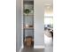 Hallway with shelf and basket next to view into living room at 8240 Grandview Ave, Arvada, CO 80002