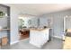 Open kitchen flowing into the living room featuring butcher block counters, stainless appliances, and ample cabinet space at 8240 Grandview Ave, Arvada, CO 80002