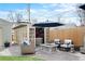 This backyard patio offers a hot tub, fire pit, seating and privacy fence at 3336 W 35Th Ave, Denver, CO 80211