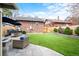 A lush backyard offers artificial turf, a stone patio with comfortable seating, and a serene space for outdoor enjoyment at 3336 W 35Th Ave, Denver, CO 80211
