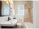 Bathroom featuring a shower-tub combo with decorative tile and an undermount sink at 3336 W 35Th Ave, Denver, CO 80211