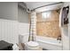 Bathroom features a shower-tub combo with decorative tile and a toilet at 3336 W 35Th Ave, Denver, CO 80211