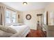 Inviting bedroom with a plush white bed, hardwood floors, and lots of natural light at 3336 W 35Th Ave, Denver, CO 80211