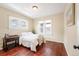 This cozy bedroom features wood floors, a large bed, and ample natural light at 3336 W 35Th Ave, Denver, CO 80211