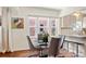 Bright dining area featuring large windows, hardwood floors, and modern furnishings adjacent to the kitchen at 3336 W 35Th Ave, Denver, CO 80211