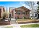 Charming brick home with a covered front porch and inviting curb appeal, landscaped for easy care at 3336 W 35Th Ave, Denver, CO 80211