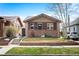 Charming brick home with a well-manicured front yard, stone accents, and a neatly kept lawn at 3336 W 35Th Ave, Denver, CO 80211