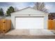 A detached two-car garage with a white door, sits in the back of this property at 3336 W 35Th Ave, Denver, CO 80211