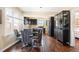 Modern eat-in kitchen features dark cabinets, stainless steel appliances, and a sleek dining table at 3336 W 35Th Ave, Denver, CO 80211