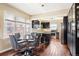 Stylish kitchen and dining area showcasing dark cabinets, stainless steel appliances, and great natural light at 3336 W 35Th Ave, Denver, CO 80211