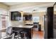 Kitchen with stainless steel appliances, dark cabinets, and a breakfast bar at 3336 W 35Th Ave, Denver, CO 80211