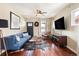 Cozy living room with hardwood floors, a blue sofa, and lots of natural light from windows at 3336 W 35Th Ave, Denver, CO 80211