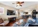 Open-concept living room with wood floors flowing into an eat-in kitchen, perfect for entertaining at 3336 W 35Th Ave, Denver, CO 80211