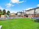 Spacious backyard with lush green lawn, swimming pool, and outdoor recreational amenities at 638 S Dudley St, Lakewood, CO 80226