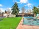 Spacious backyard with a covered pool and green turf at 638 S Dudley St, Lakewood, CO 80226