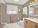 Well-lit bathroom with a modern vanity, elegant fixtures, and a large window for natural light at 638 S Dudley St, Lakewood, CO 80226
