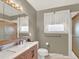 Bathroom featuring a modern vanity with sink, new fixtures, and ample lighting at 638 S Dudley St, Lakewood, CO 80226