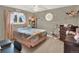 Cozy bedroom with charming decor, a ceiling fan, and a window providing natural light at 638 S Dudley St, Lakewood, CO 80226