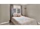Cozy bedroom featuring a comfortable bed, natural light from the windows, and soft neutral tones at 638 S Dudley St, Lakewood, CO 80226