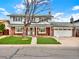 Charming two-story home with a brick facade, well-manicured lawn, and inviting entrance at 638 S Dudley St, Lakewood, CO 80226