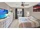 Bright main bedroom featuring neutral walls, TV, and plenty of storage with white cabinets at 638 S Dudley St, Lakewood, CO 80226