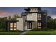 Modern, three-story home featuring a combination of stone and dark gray siding, with black trim on the windows and roofline at 4444 W 28Th Ave, Denver, CO 80212
