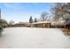 Backyard view of house, covered in winter snow at 428 S Uvalda St, Aurora, CO 80012