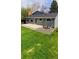 Backyard featuring lawn, stone landscaping, and a concrete patio at 6521 Zinnia St, Arvada, CO 80004