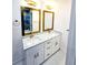 Bathroom featuring a double sink vanity with quartz countertops and gold fixtures and hardware at 6521 Zinnia St, Arvada, CO 80004