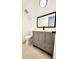 Chic bathroom with gray vanity, black hardware, and a large mirror, offering a modern and stylish space at 6521 Zinnia St, Arvada, CO 80004