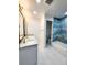 Bathroom featuring dual sink vanity with walk-in shower and tub with custom tile work at 6521 Zinnia St, Arvada, CO 80004