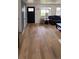 Bright living room featuring new floors, a black front door and a cozy seating area at 6521 Zinnia St, Arvada, CO 80004