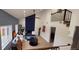 Open-concept living room with vaulted ceilings, a unique fireplace, and access to the upstairs at 6521 Zinnia St, Arvada, CO 80004