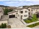 Aerial view showcasing this charming two-story home with a basketball hoop over the garage and mountain views at 15547 W Vassar Ave, Lakewood, CO 80228