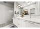 Bright bathroom boasts double sinks, modern fixtures, glass shower, and lots of natural light at 15547 W Vassar Ave, Lakewood, CO 80228