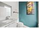 Stylish half bathroom featuring granite counters, modern fixtures, and attractive wall art at 15547 W Vassar Ave, Lakewood, CO 80228