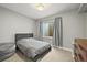 Cozy bedroom with neutral colors, comfortable bed, and natural light from the window at 15547 W Vassar Ave, Lakewood, CO 80228