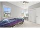 Bright bedroom with three windows offering neighborhood views, features carpet and ceiling fan at 15547 W Vassar Ave, Lakewood, CO 80228
