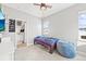 Cozy bedroom with natural light, featuring carpet floors and a view of neighborhood buildings at 15547 W Vassar Ave, Lakewood, CO 80228