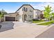 Charming two-story home featuring a basketball hoop over the garage and well-manicured front yard at 15547 W Vassar Ave, Lakewood, CO 80228