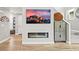 Modern fireplace with sleek design, wall mounted television, and decorative wall art at 15547 W Vassar Ave, Lakewood, CO 80228