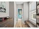 Hallway with wood-look floors and custom built-in storage leading to a bright powder room at 15547 W Vassar Ave, Lakewood, CO 80228