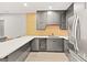 Contemporary kitchen boasts stainless steel appliances, and white countertops at 15547 W Vassar Ave, Lakewood, CO 80228